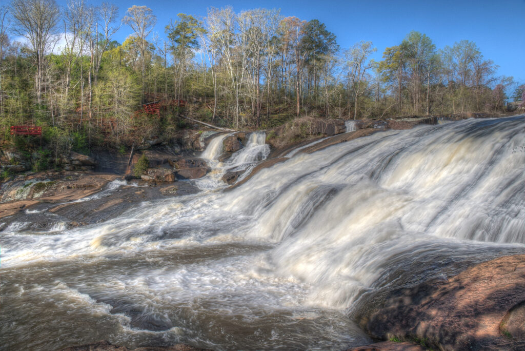 The High Falls waterfall cascading over granite rock on the Towaliga River at High Falls State Park, Jackson, Georgia