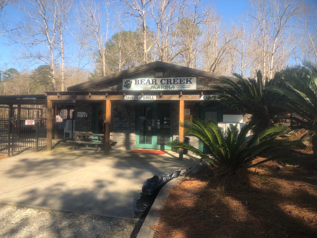 Rustic Bear Creek Marina wooden entrance sign on Jackson Lake in Mansfield, GA