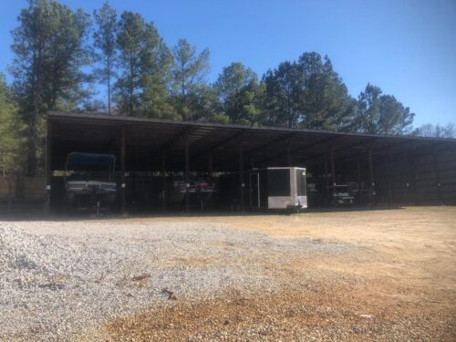 Hurricane season boat storage at Bear Creek Marina: boats and an RV parked under a covered roof on Jackson Lake, GA